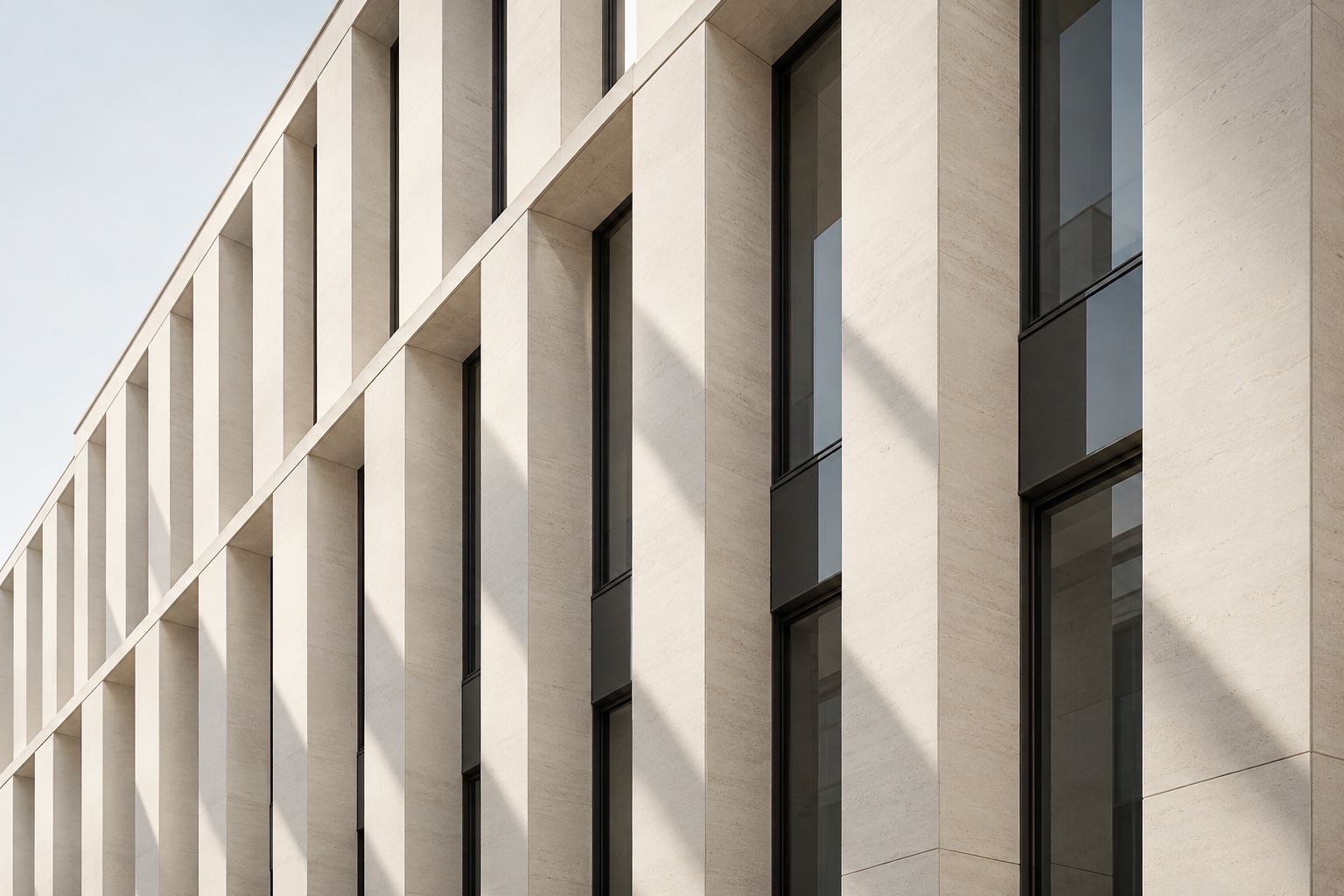 Sculptural limestone architecture with clean vertical lines and natural shadows